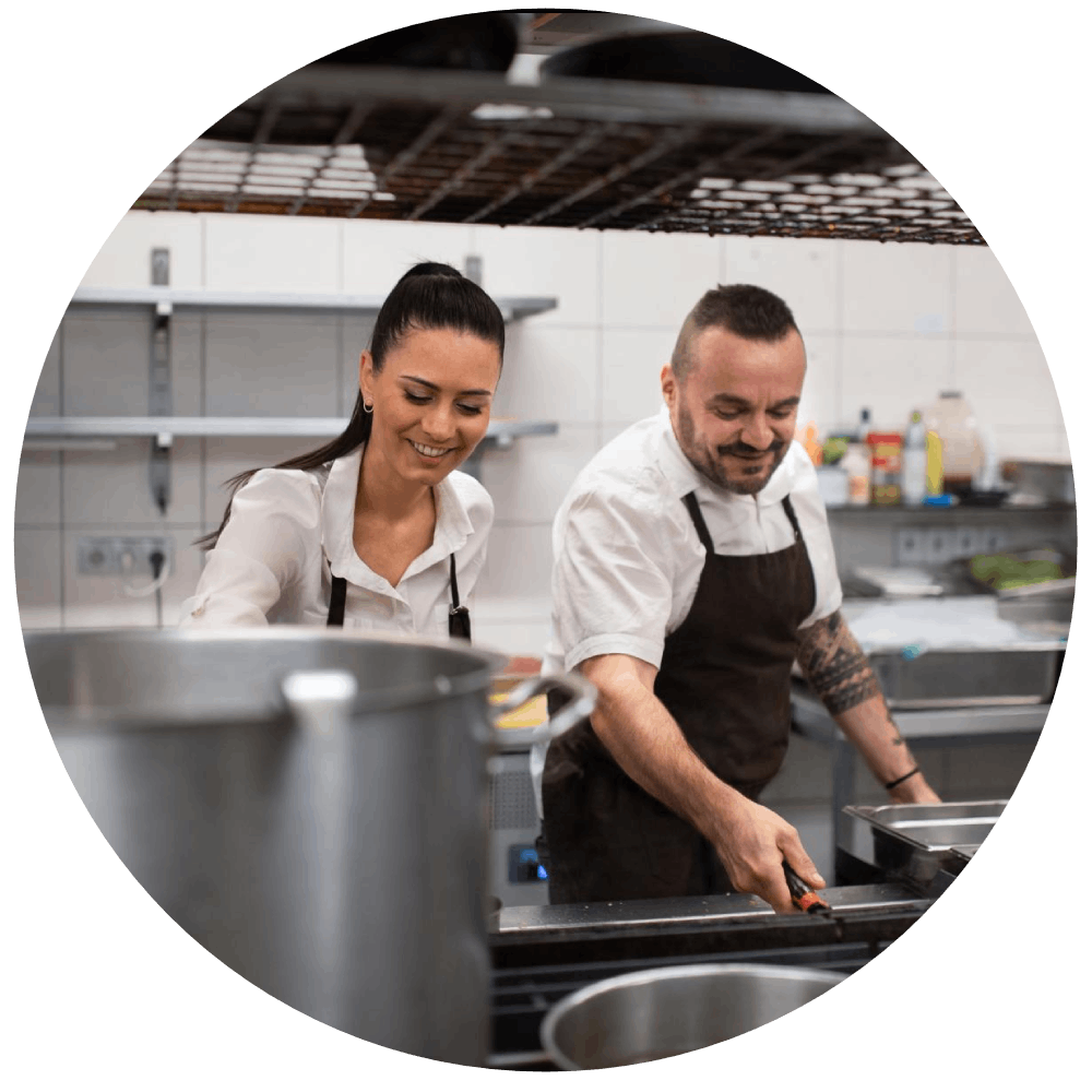 Male and female chef cooking in kitchen